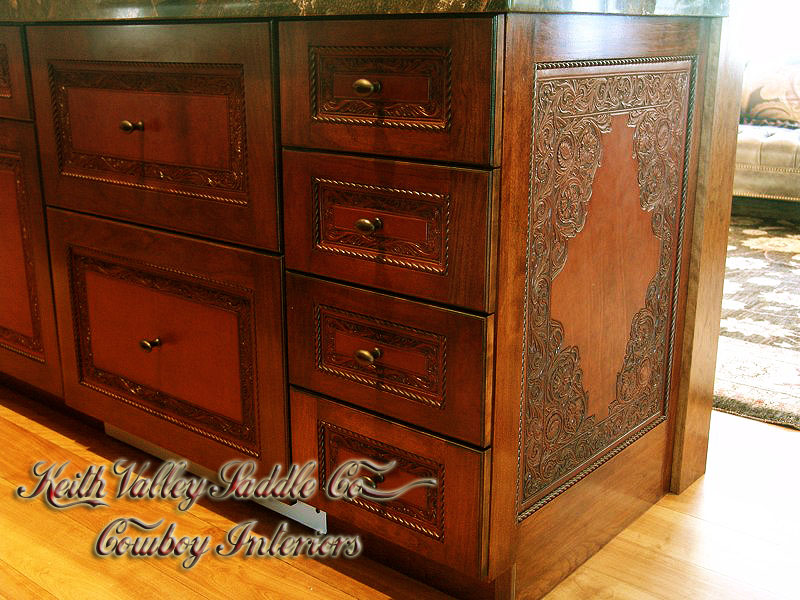 Every drawer and cabinet face designed with custom cowboy interior designs that are deeply hand carved, with greatest care, on the leather. Each piece has the eye appeal and a sense of living flow.  All original cowboy art designs by Keith Valley